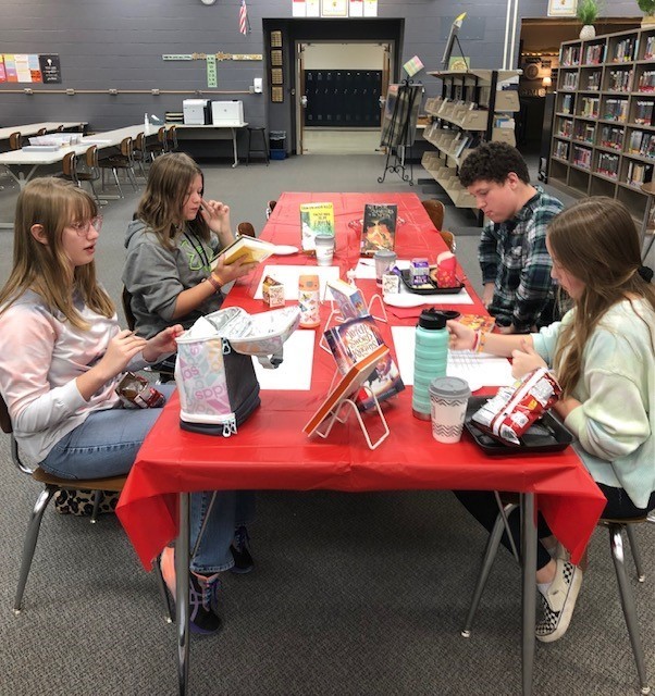 Eighth graders enjoying lunch, treats and books!