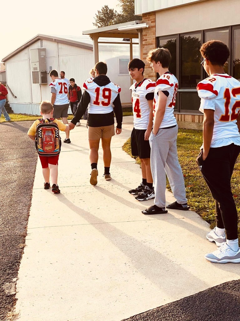Football players walking in students at Mark Twain