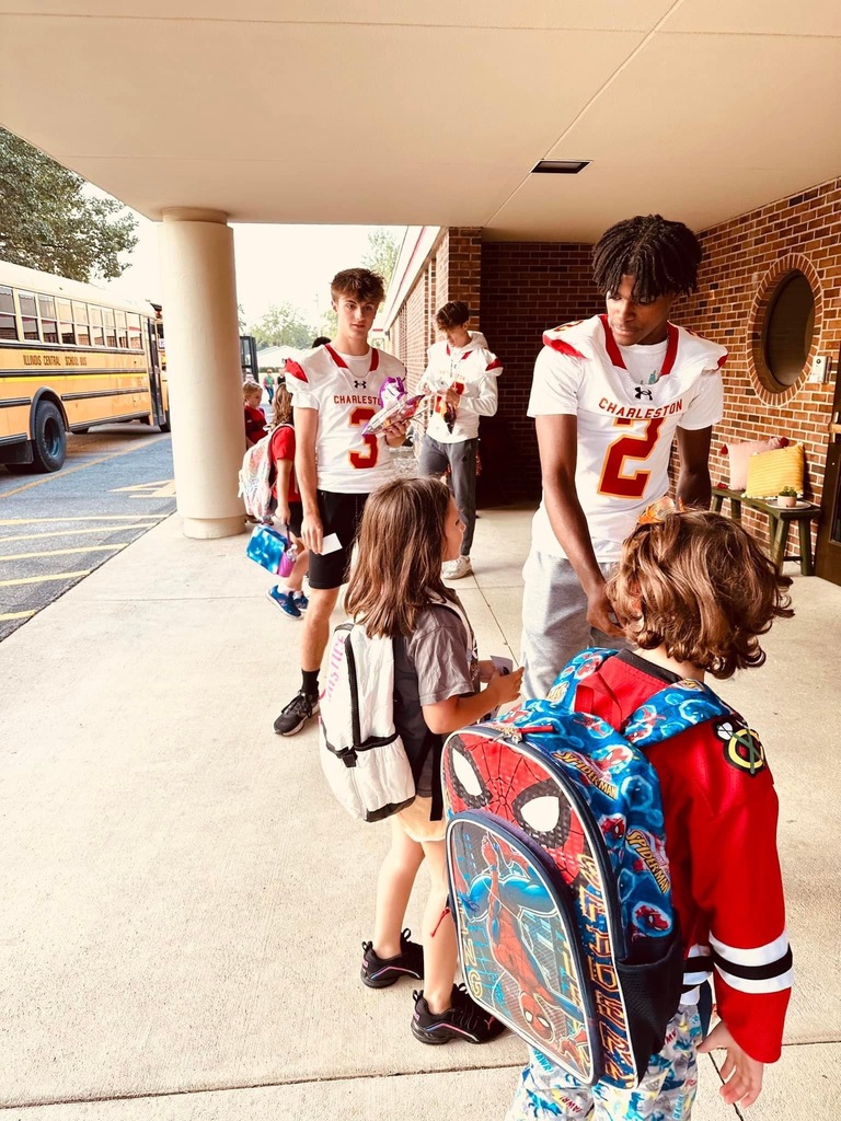 Football players walking in students at Carl Sandburg