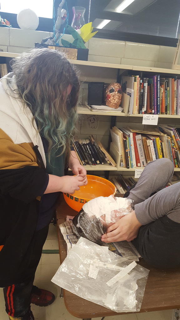Two students casting a mask